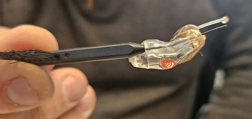 Internal vent allowing unamplified frequencies to pass directly into the ear